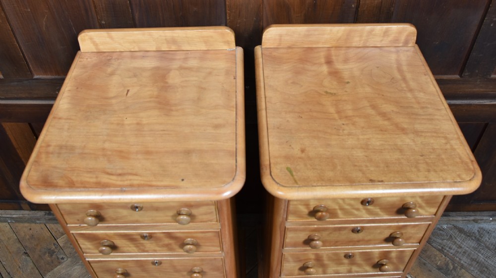 A pair of tall Victorian satin birch bedside chests featuring five drawers with turned wooden knobs and a low gallery top. View VIII