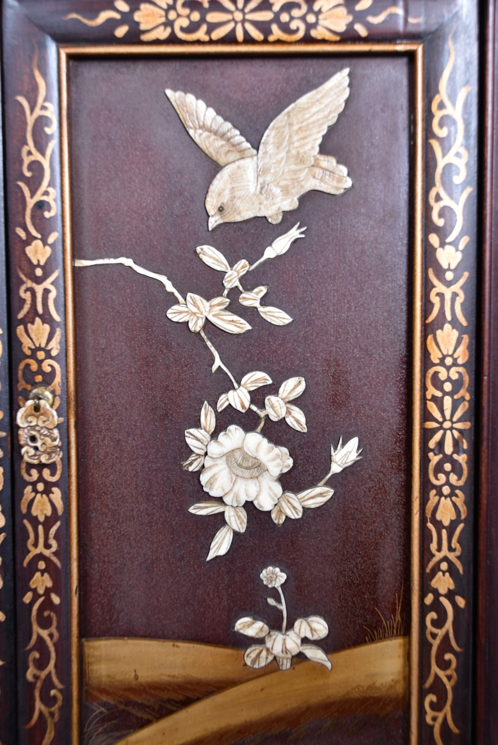 A tall Japanese Meiji period dark hardwood shodana cabinet featuring asymmetrical shelving, mother-of-pearl inlaid panels, bird carvings, and a cresting pediment. View XVIII