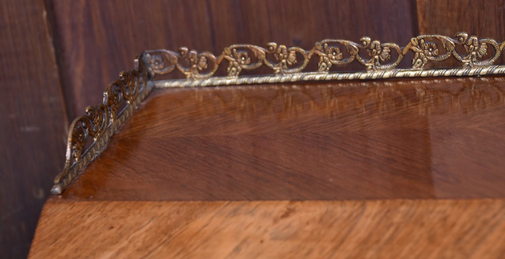 A 19th-century French rosewood bureau de dame featuring slender cabriole legs, brass mounts, a brass gallery top, and a hand-painted scene on the slanted flap front. View III