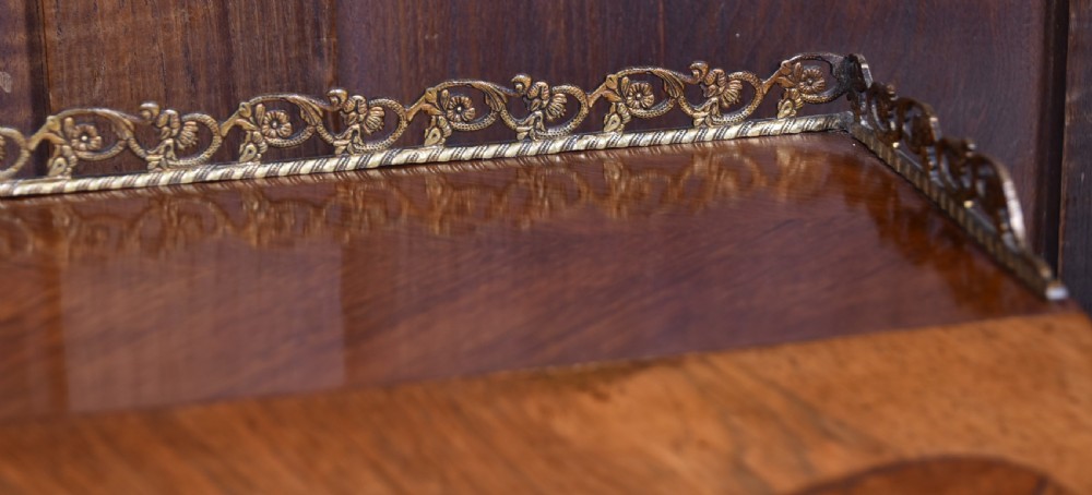 A 19th-century French rosewood bureau de dame featuring slender cabriole legs, brass mounts, a brass gallery top, and a hand-painted scene on the slanted flap front. View VI