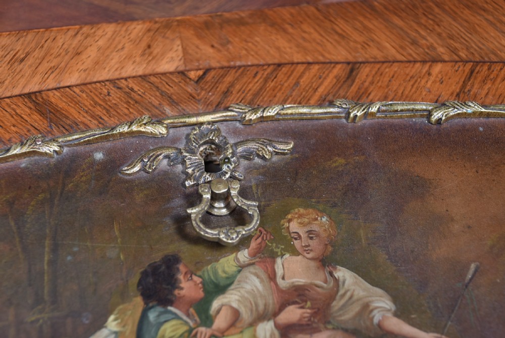 A 19th-century French rosewood bureau de dame featuring slender cabriole legs, brass mounts, a brass gallery top, and a hand-painted scene on the slanted flap front. View VII