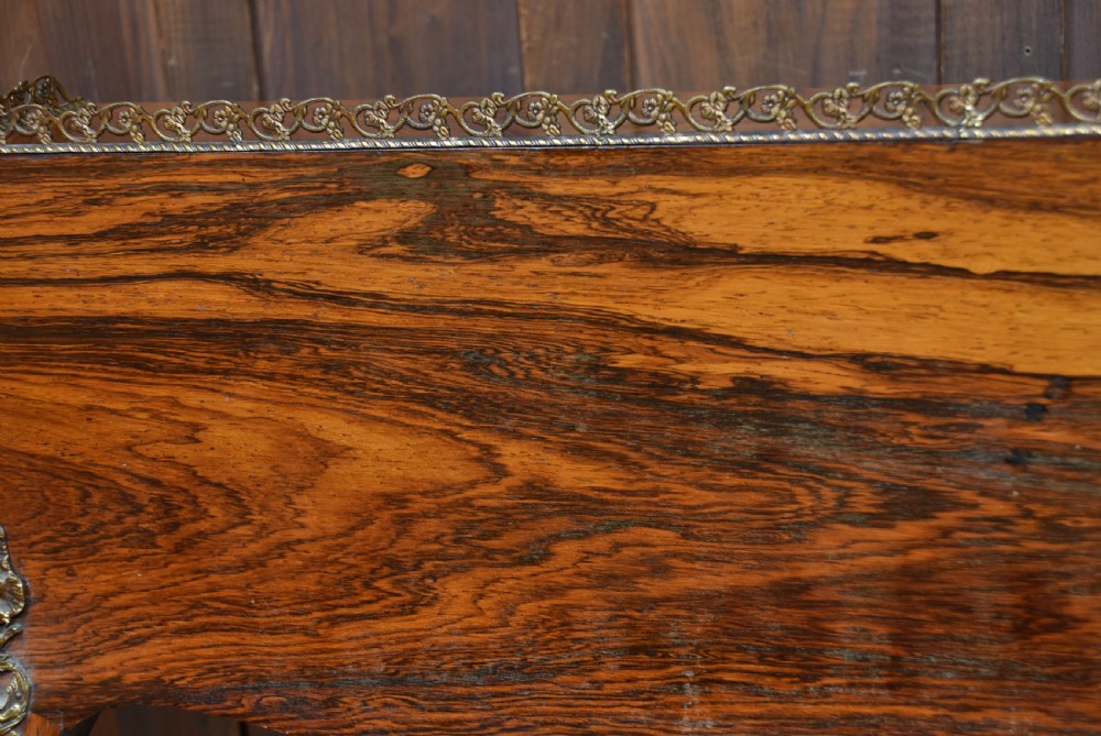 A 19th-century French rosewood bureau de dame featuring slender cabriole legs, brass mounts, a brass gallery top, and a hand-painted scene on the slanted flap front. View XVI