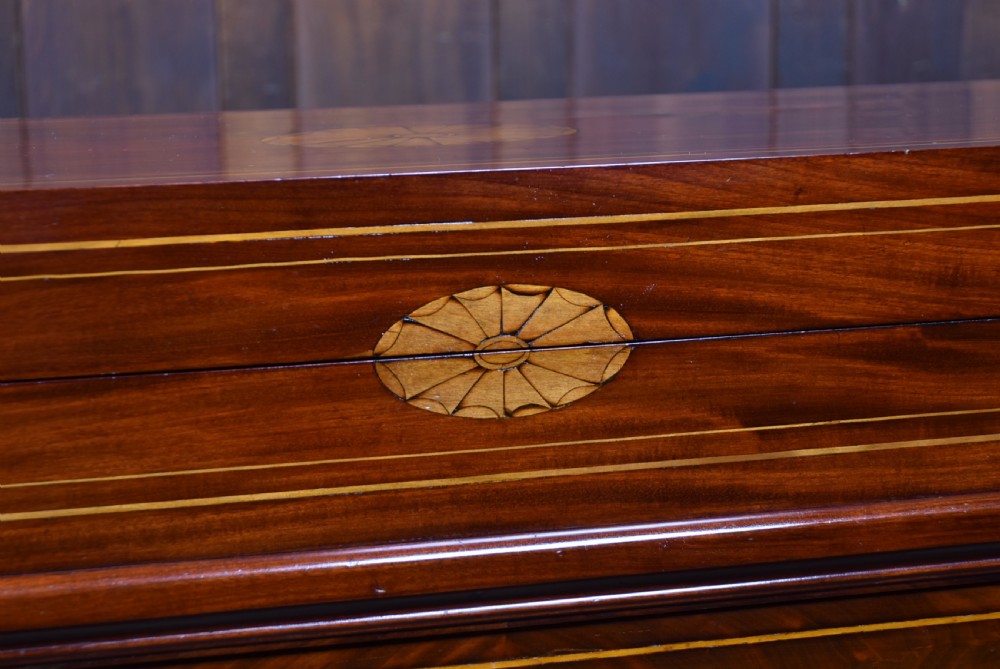 An antique Georgian mahogany writing desk with satinwood oval patera inlays, geometric stringing, two cupboard doors, and a hinged lid. View II