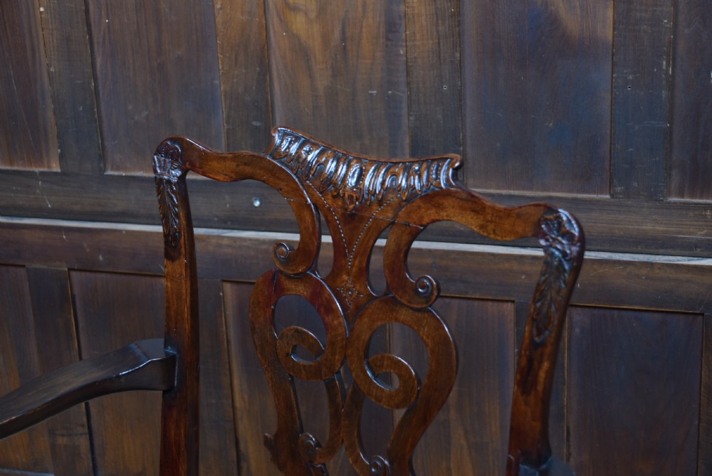 A Georgian mahogany open armchair featuring a pierced carved back splat, out-swept arms, patterned upholstery, and cabriole front legs. View II