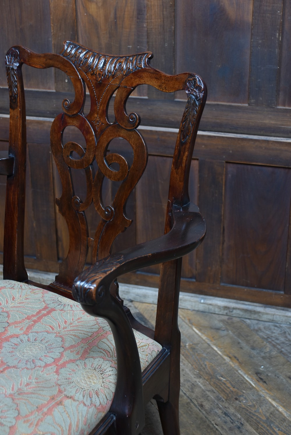 A Georgian mahogany open armchair featuring a pierced carved back splat, out-swept arms, patterned upholstery, and cabriole front legs. View V