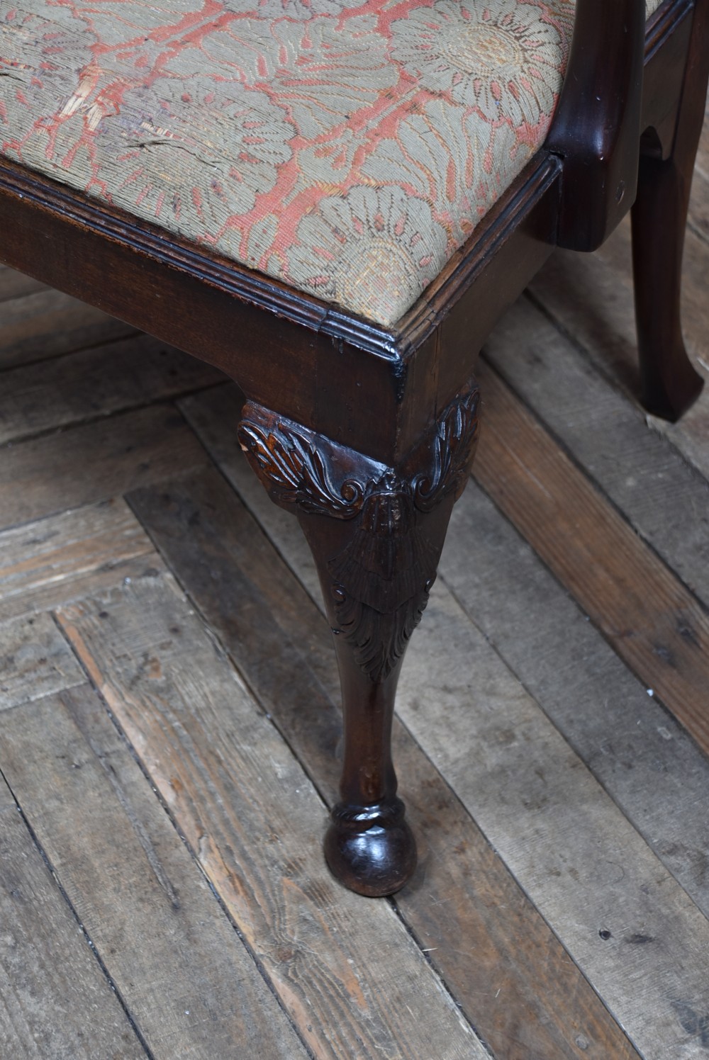 A Georgian mahogany open armchair featuring a pierced carved back splat, out-swept arms, patterned upholstery, and cabriole front legs. View VI