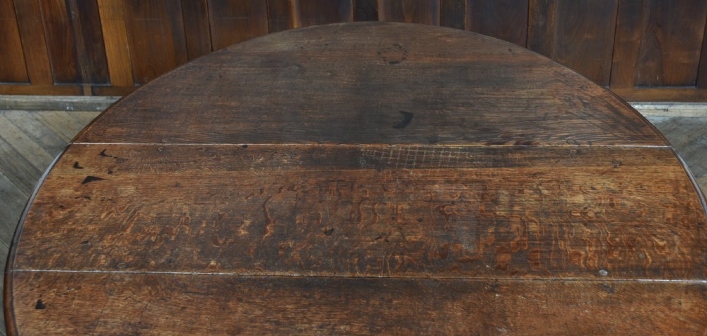 An 18th-century dark oak drop-leaf table featuring barley-twist turned legs, stretchers, and hinged folding side panels. View XIV