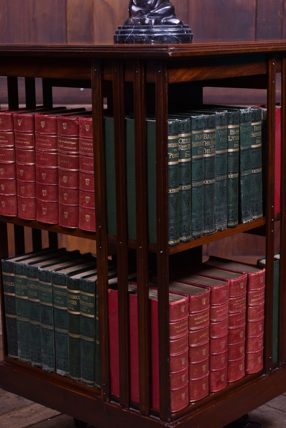 An Edwardian two-tier mahogany revolving bookcase with vertical slatted sides and a polished square top. View II