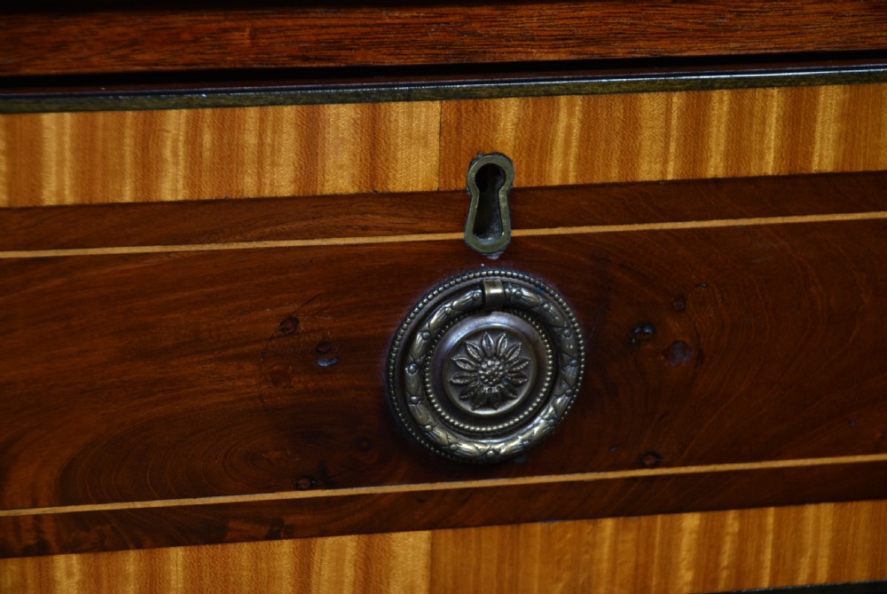 A Georgian mahogany chest of drawers featuring two short over two long drawers with intricate inlaid borders and splayed bracket feet. View VII