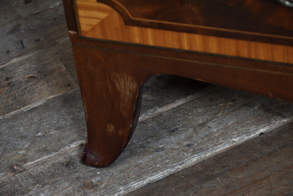 A Georgian mahogany chest of drawers featuring two short over two long drawers with intricate inlaid borders and splayed bracket feet. View VIII