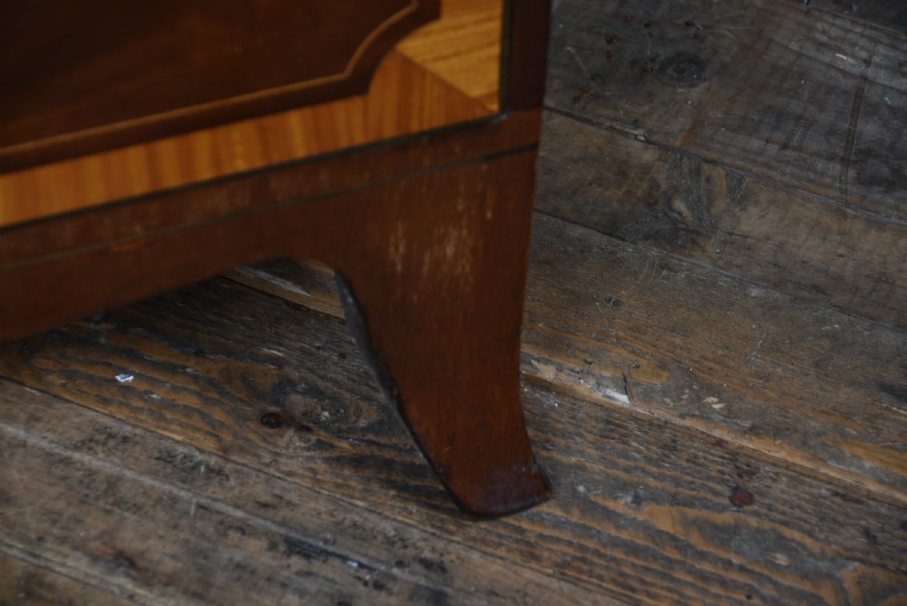 A Georgian mahogany chest of drawers featuring two short over two long drawers with intricate inlaid borders and splayed bracket feet. View IX