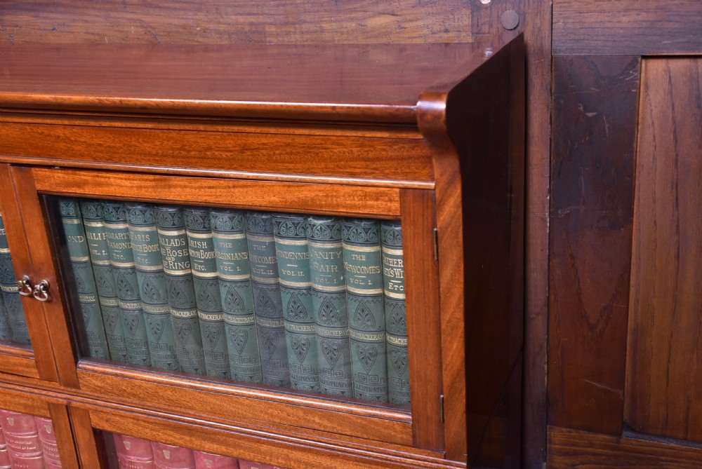 A pair of three-tier Edwardian mahogany sectional bookcases with glazed double doors and small brass handles placed side by side. View III