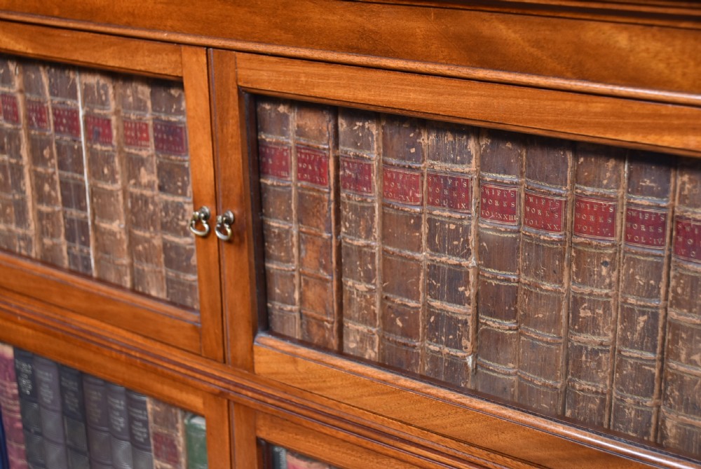A pair of three-tier Edwardian mahogany sectional bookcases with glazed double doors and small brass handles placed side by side. View IV