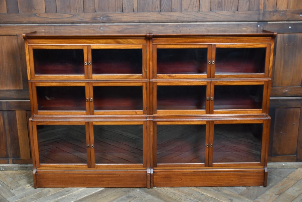 A pair of three-tier Edwardian mahogany sectional bookcases with glazed double doors and small brass handles placed side by side. View VII