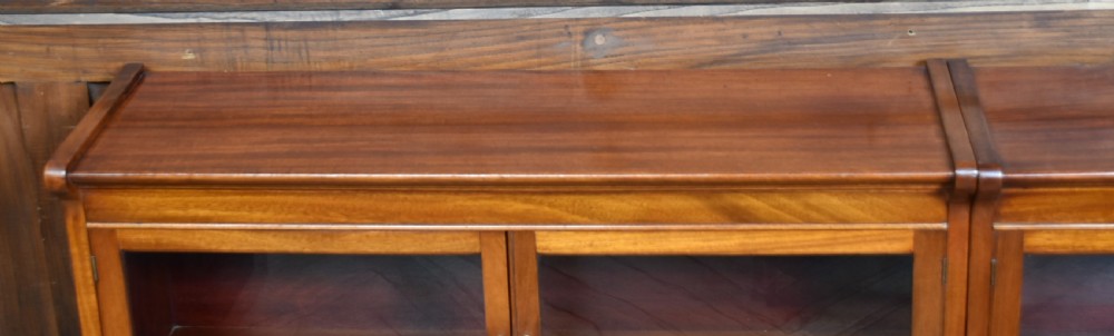 A pair of three-tier Edwardian mahogany sectional bookcases with glazed double doors and small brass handles placed side by side. View XI