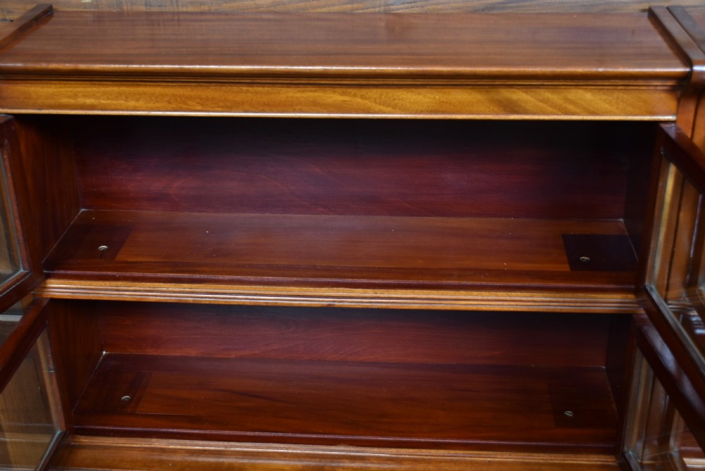 A pair of three-tier Edwardian mahogany sectional bookcases with glazed double doors and small brass handles placed side by side. View XIII
