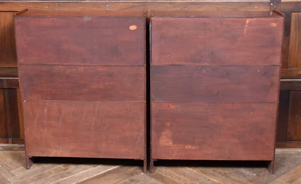 A pair of three-tier Edwardian mahogany sectional bookcases with glazed double doors and small brass handles placed side by side. View XV