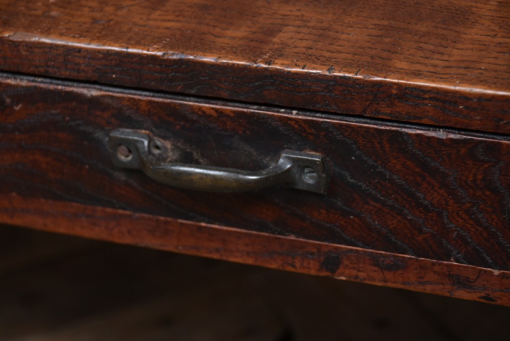 A low dark brown wooden Japanese calligraphy writing table featuring three drawers with iron handles and solid slab side supports. View VIII
