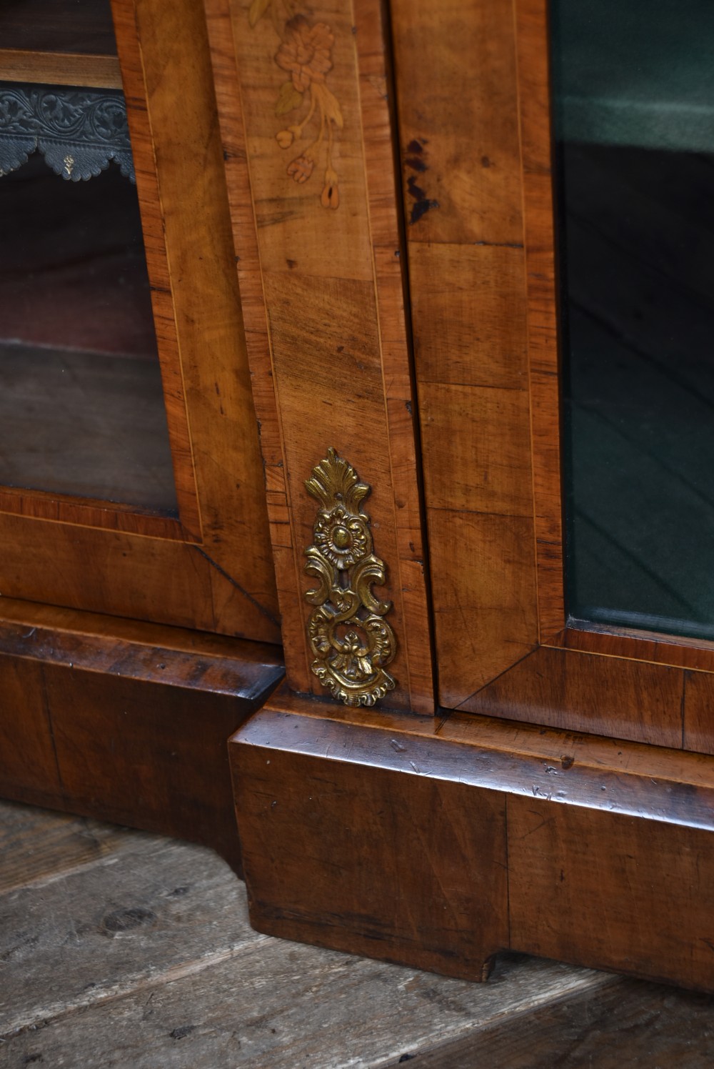 A low Victorian burr walnut breakfront bookcase featuring three arched glass doors, floral marquetry inlay, and gilt bronze mounts. View VIII