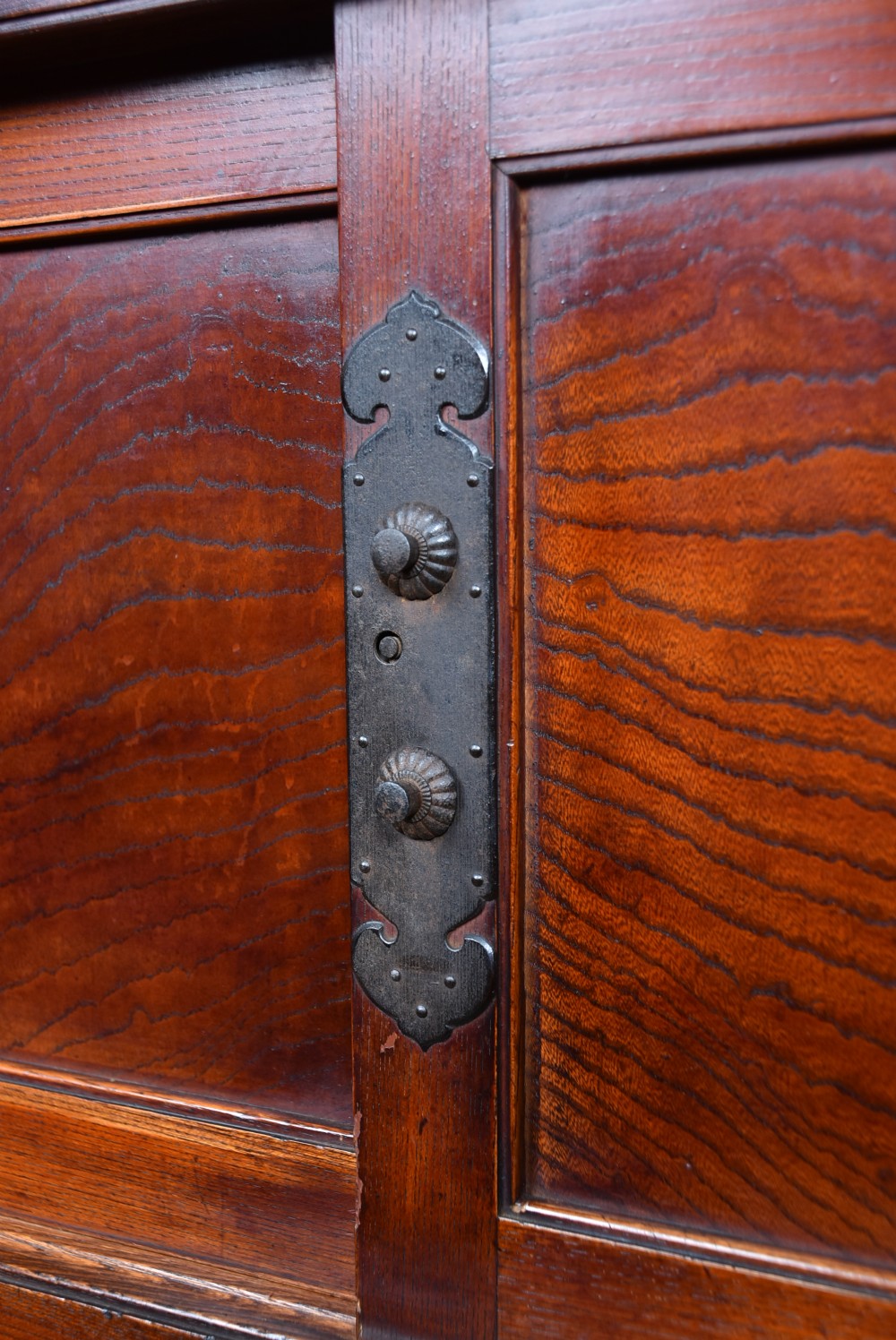 A stacked three-tier Japanese Tansu storage cabinet made of rich warm brown wood with iron handles and sliding panel doors. View III