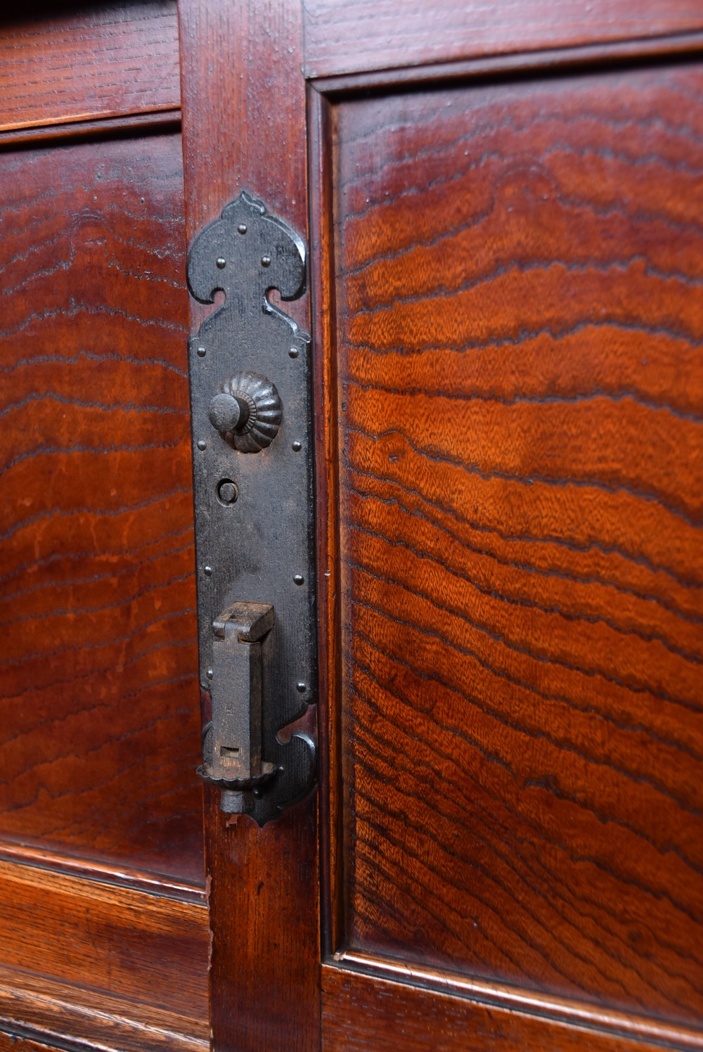 A stacked three-tier Japanese Tansu storage cabinet made of rich warm brown wood with iron handles and sliding panel doors. View IV