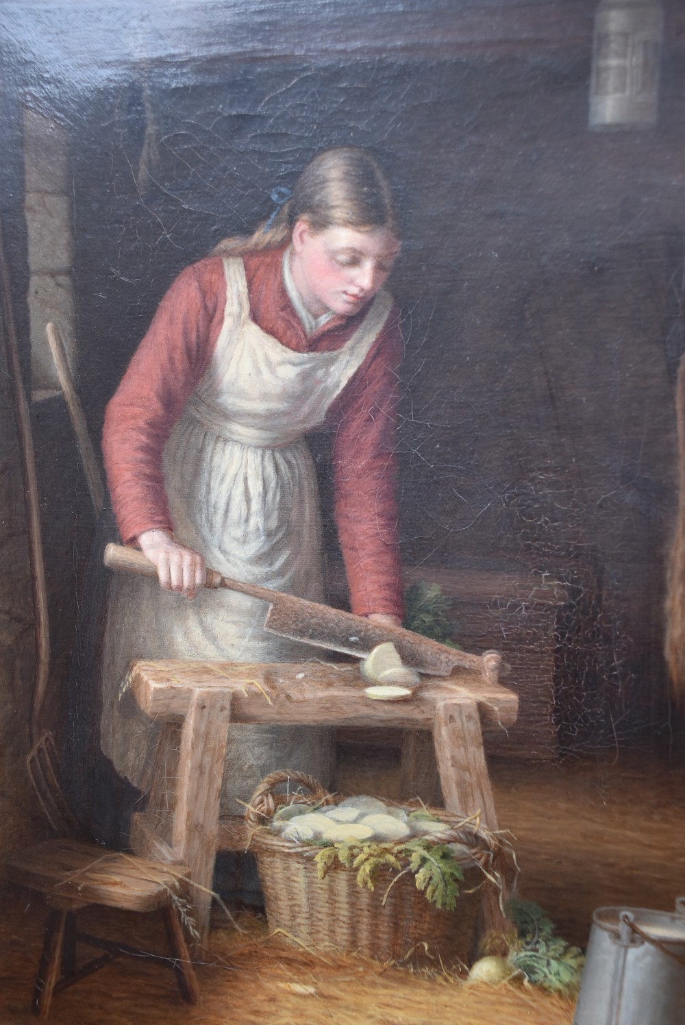 An oil painting depicting a woman working in a barn chopping vegetables beside a basket, housed within a gold carved frame decorated with oak leaves and acorns. View VIII