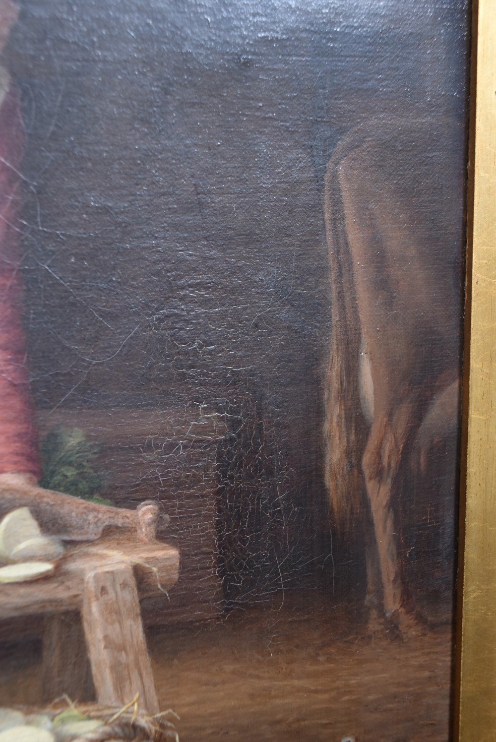 An oil painting depicting a woman working in a barn chopping vegetables beside a basket, housed within a gold carved frame decorated with oak leaves and acorns. View IX