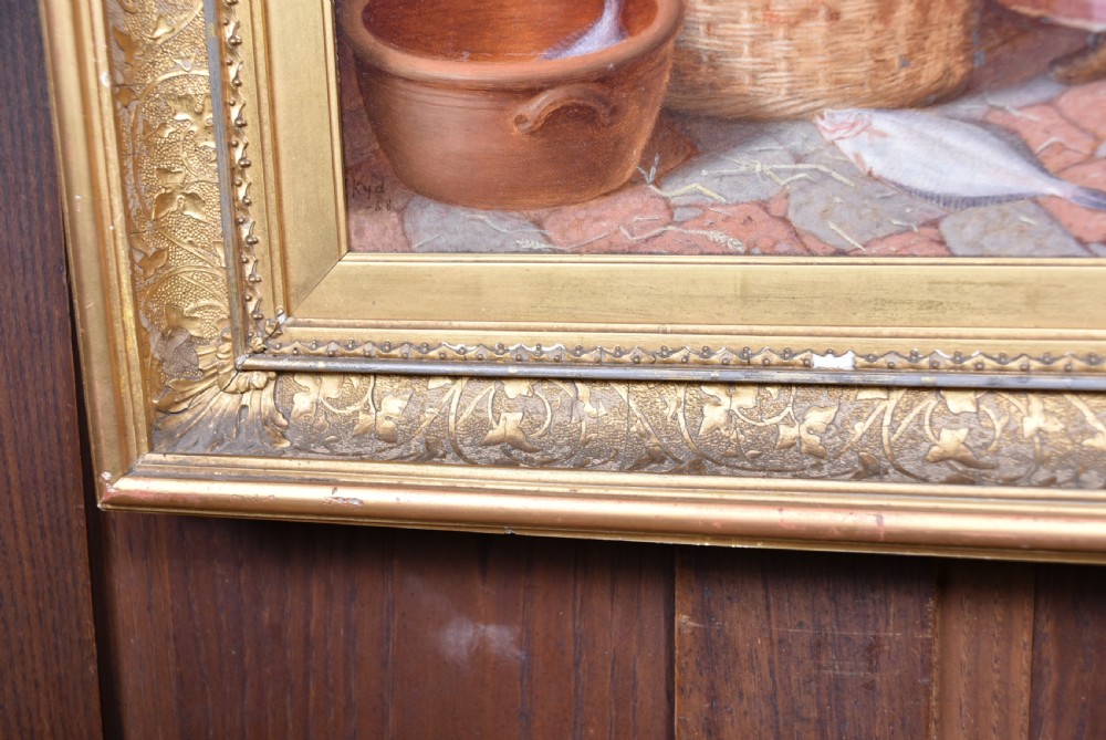 A Victorian oil painting on wood panel depicting a fisherman packing a wicker basket alongside a young girl, set within an ornate gilded frame. View V