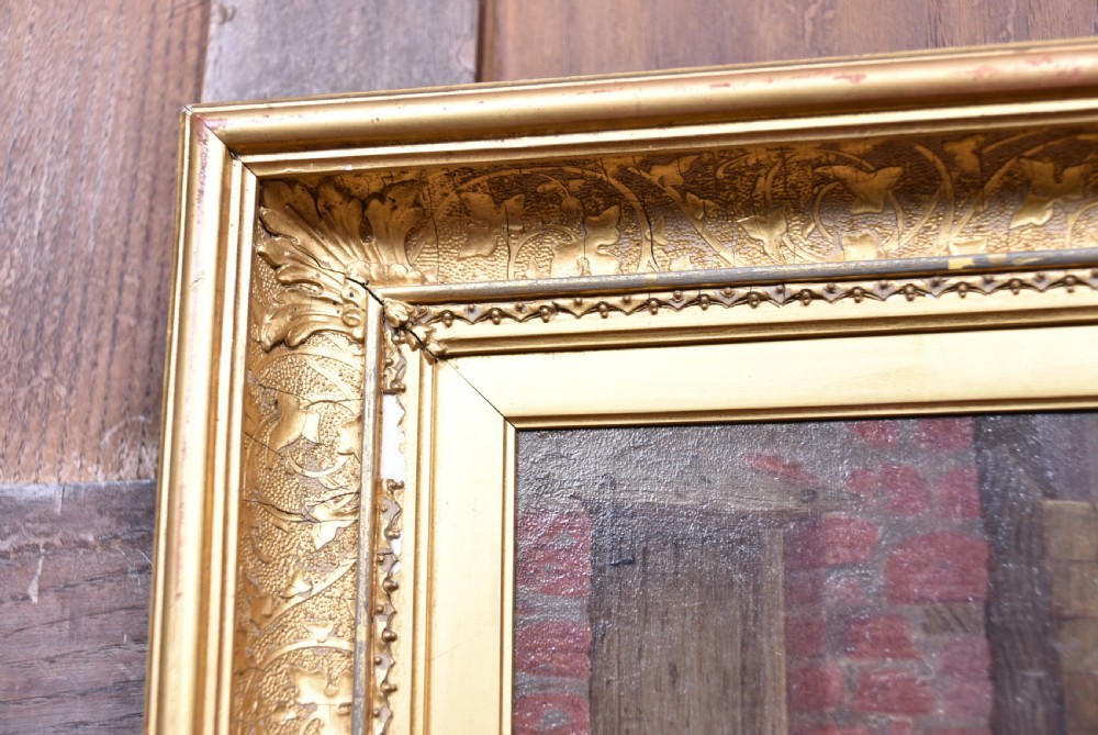 A Victorian oil painting on wood panel depicting a fisherman packing a wicker basket alongside a young girl, set within an ornate gilded frame. View VI