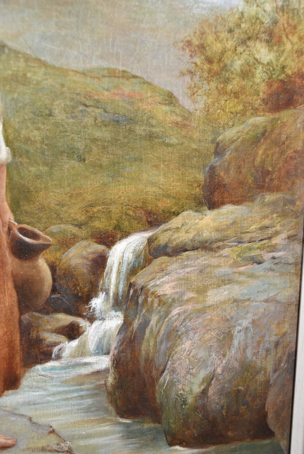 Framed oil painting depicting a young barefoot woman carrying clay jugs beside a stream in a Scottish Highland landscape. View II