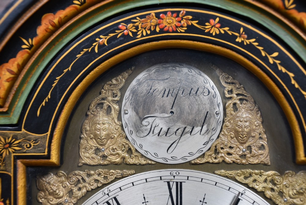 A slim black lacquered grandmother clock featuring hand-painted gilt chinoiserie landscape decoration, an arched hood, and a Roman numeral dial. View VII
