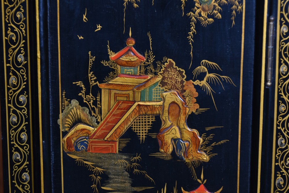 A slim black lacquered grandmother clock featuring hand-painted gilt chinoiserie landscape decoration, an arched hood, and a Roman numeral dial. View XXVI