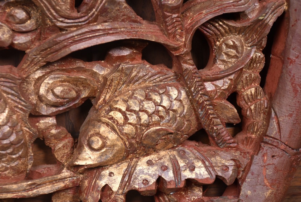 A circular 19th-century Chinese carved wooden wall plaque featuring gilded relief carvings of a dragon, carp, and pagodas. View VI