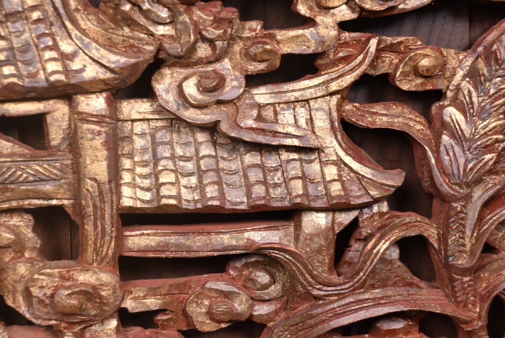 A circular 19th-century Chinese carved wooden wall plaque featuring gilded relief carvings of a dragon, carp, and pagodas. View VIII