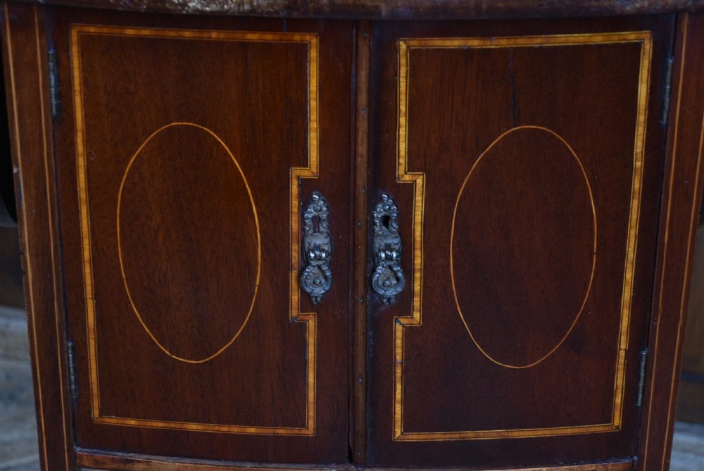 An Edwardian mahogany drop-leaf side table featuring satinwood inlaid cupboard doors and slender legs. View III