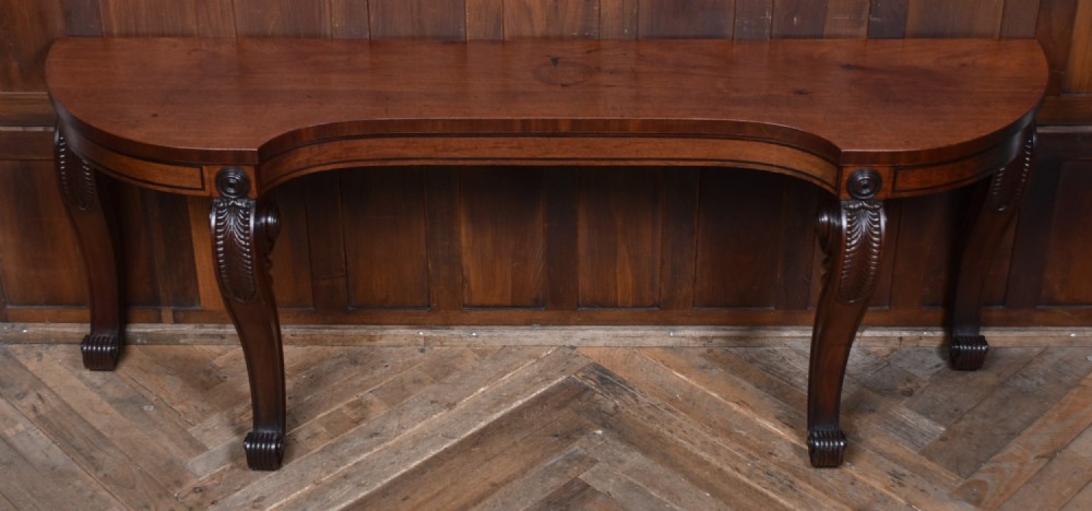 A 19th-century mahogany console table featuring a shaped top, inlaid frieze, and four carved scroll legs. View III