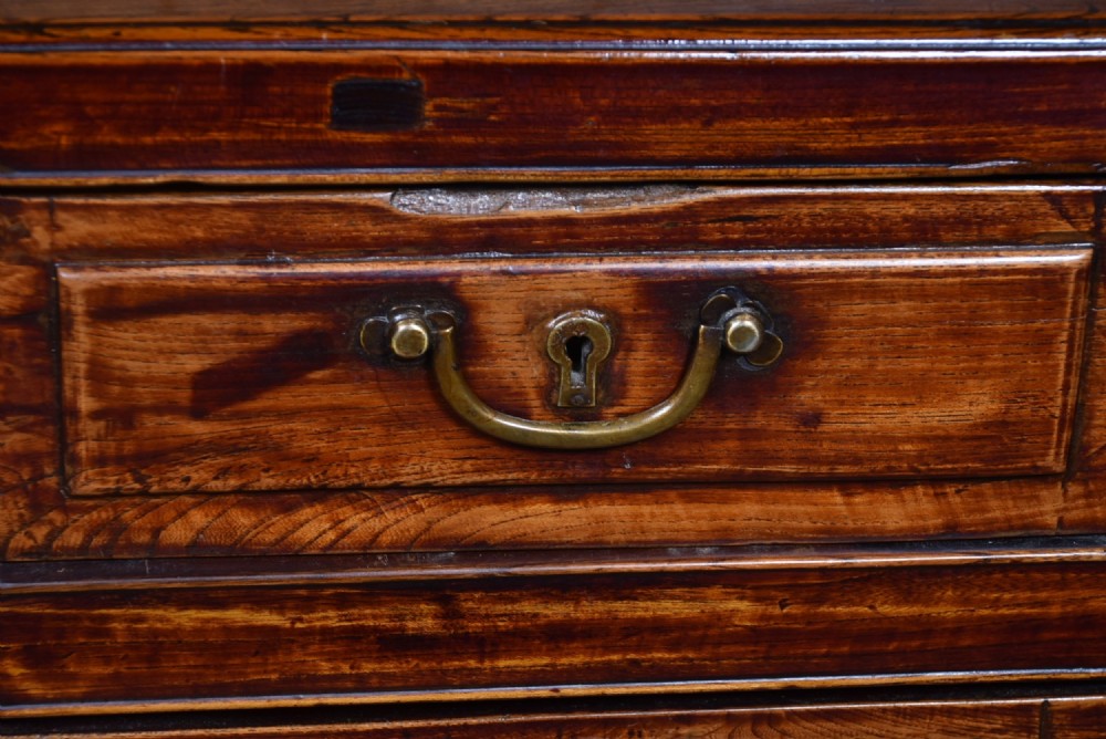 A traditional Chinese warm brown hardwood partners desk featuring six front drawers with brass drop handles and square legs. View III
