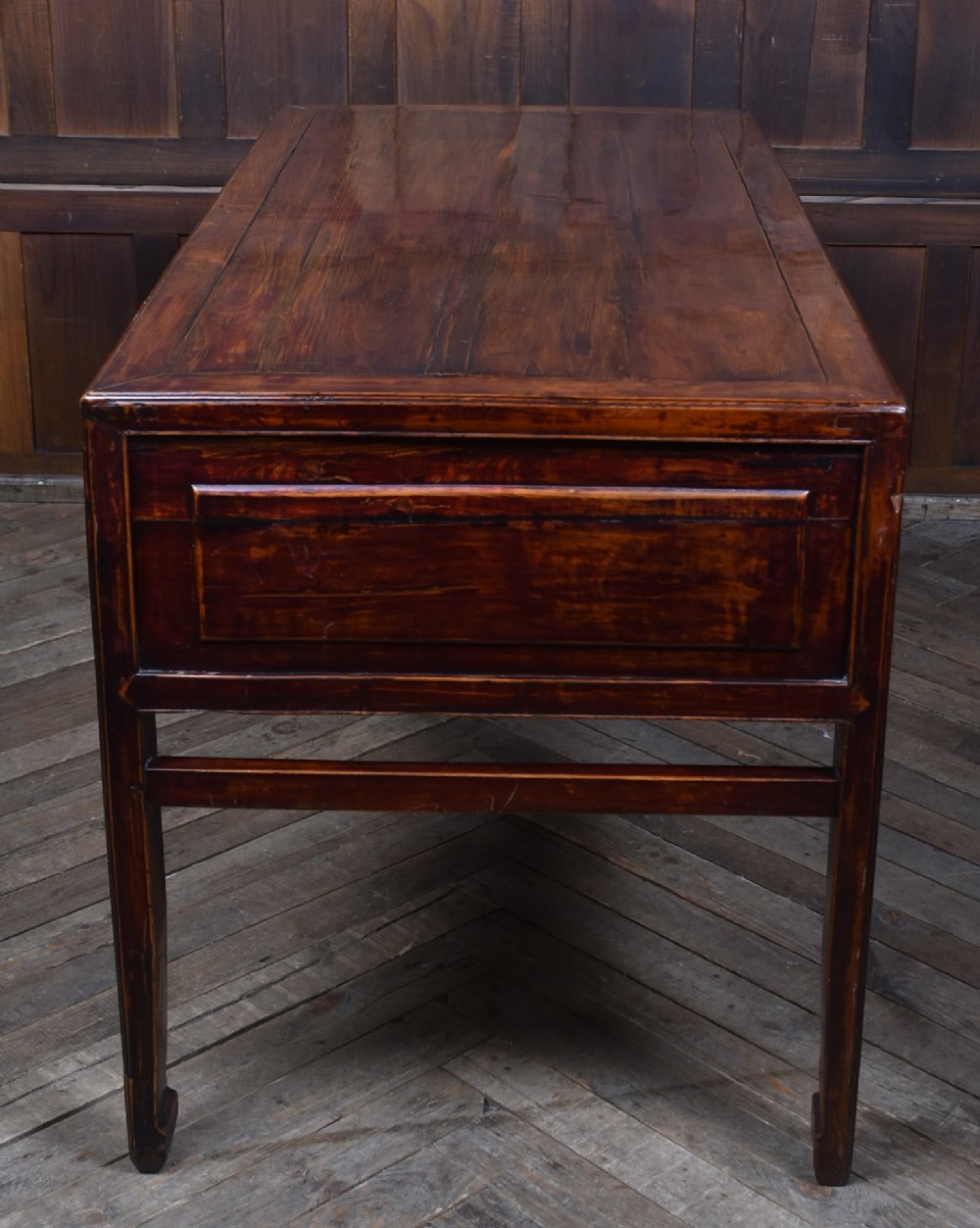 A traditional Chinese warm brown hardwood partners desk featuring six front drawers with brass drop handles and square legs. View X