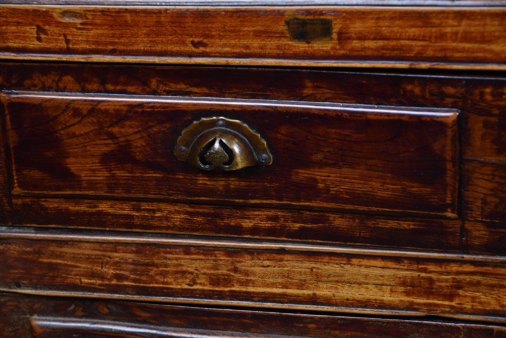 A traditional Chinese warm brown hardwood partners desk featuring six front drawers with brass drop handles and square legs. View XII
