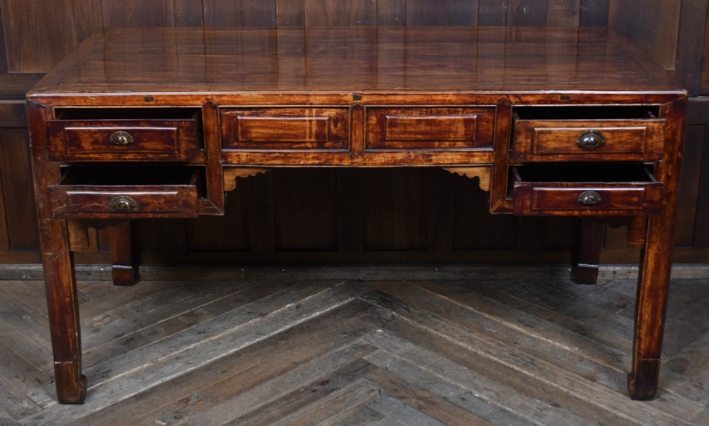 A traditional Chinese warm brown hardwood partners desk featuring six front drawers with brass drop handles and square legs. View XIII