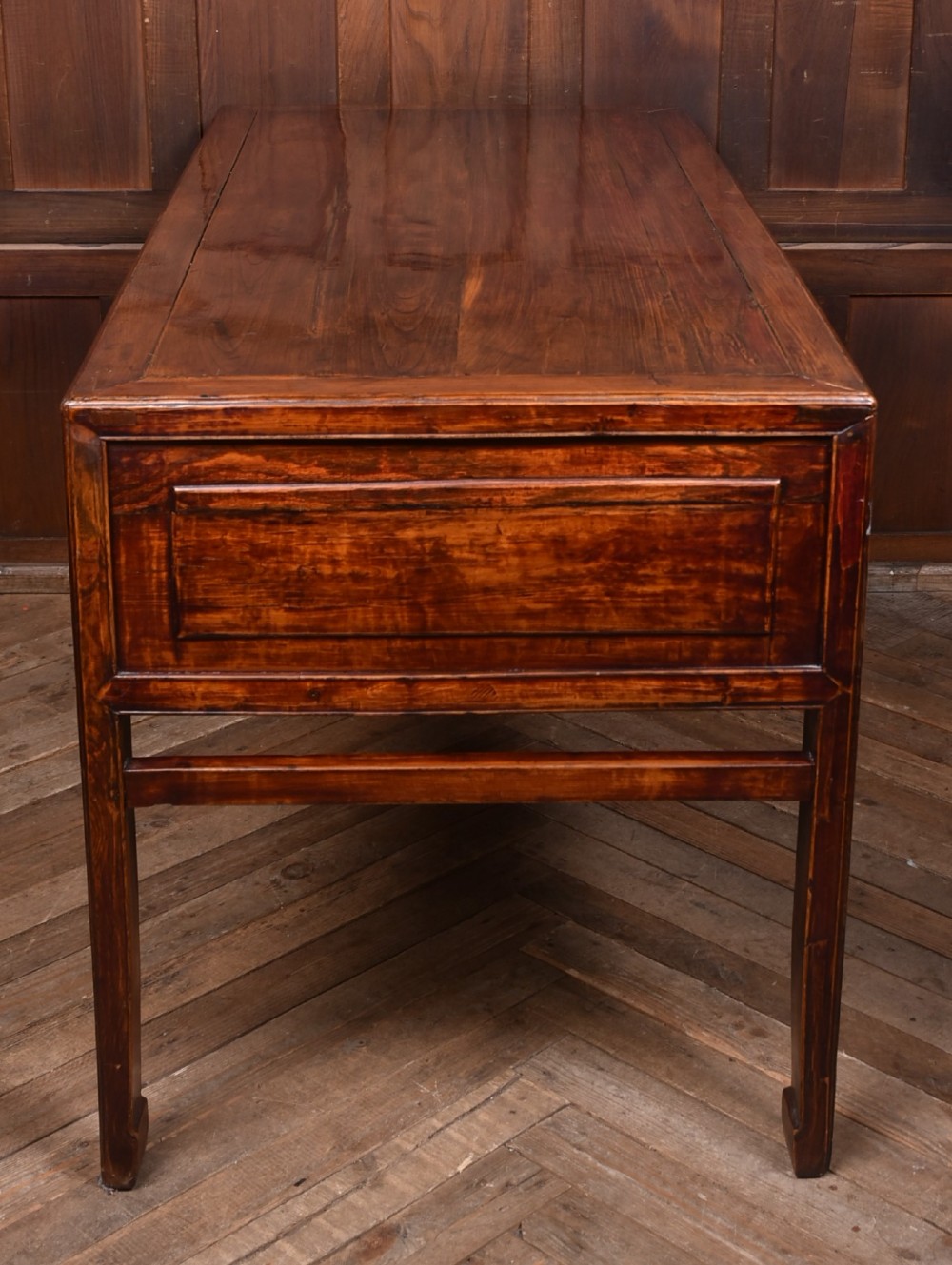 A traditional Chinese warm brown hardwood partners desk featuring six front drawers with brass drop handles and square legs. View XIV