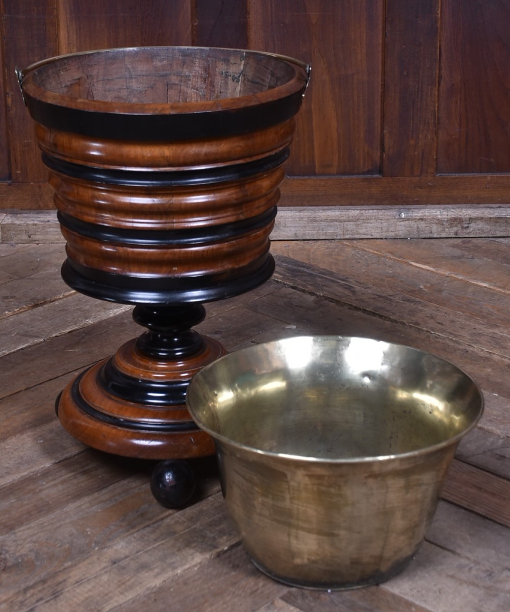 An early 19th-century Dutch teestoof bucket crafted from turned mahogany and ebonised wood with a brass swing handle and removable brass liner. View V
