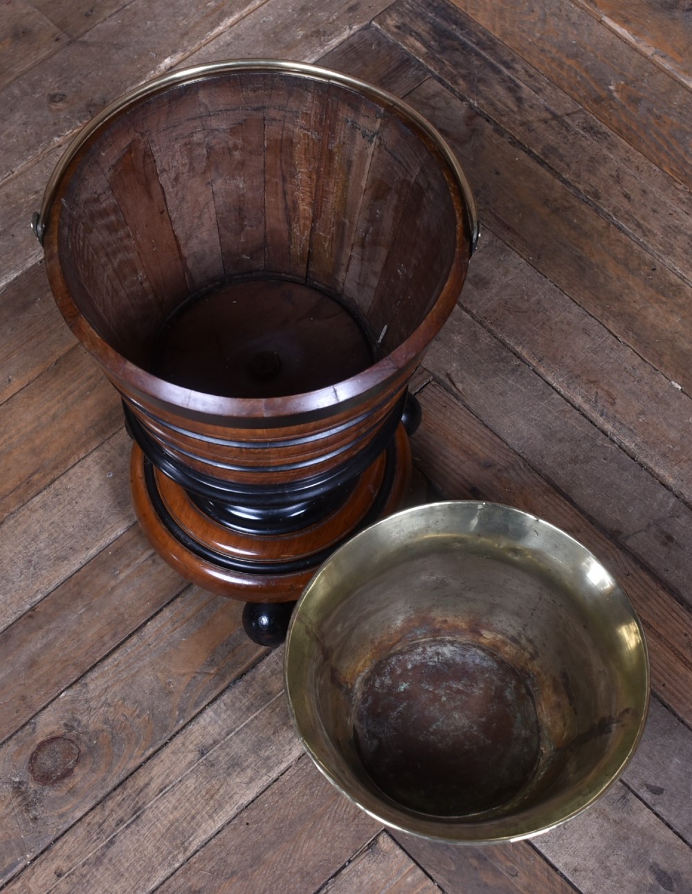 An early 19th-century Dutch teestoof bucket crafted from turned mahogany and ebonised wood with a brass swing handle and removable brass liner. View VI