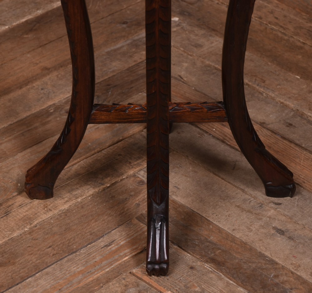 A tall dark hardwood Chinese plant stand featuring a round inset marble top, intricately carved floral aprons, and long swept legs joined by a lower central stretcher. View III