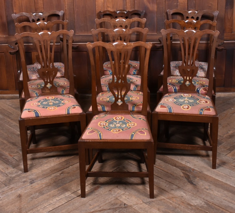 A set of ten dark brown wood dining chairs featuring carved pierced splat backs and patterned drop-in upholstered seats. View II