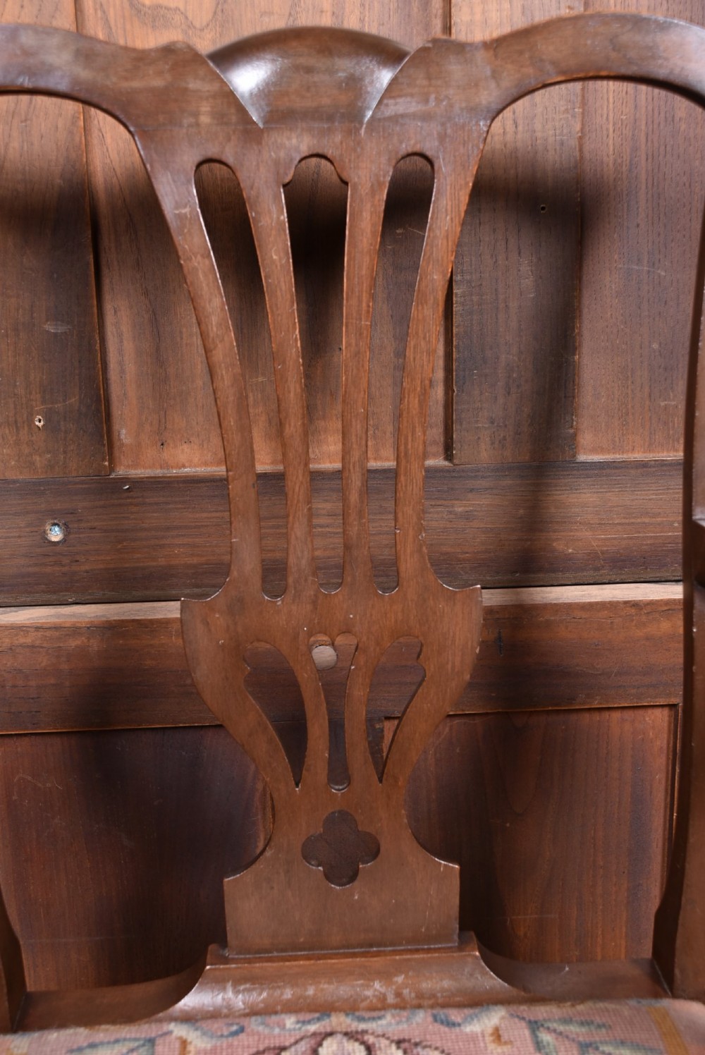 A set of ten dark brown wood dining chairs featuring carved pierced splat backs and patterned drop-in upholstered seats. View IV