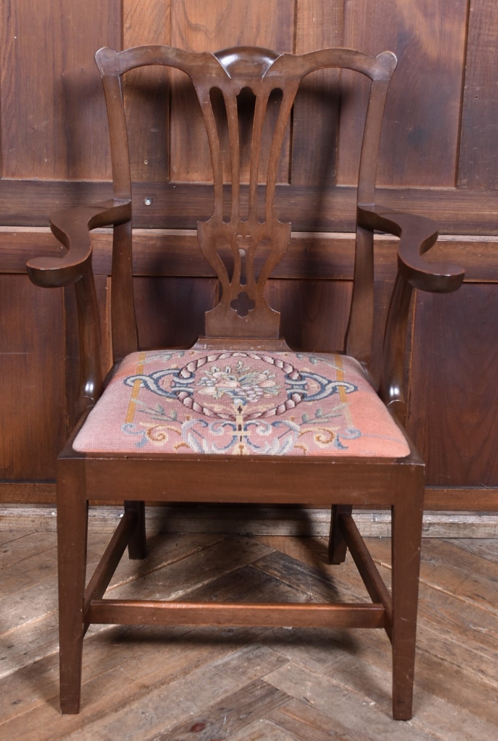 A set of ten dark brown wood dining chairs featuring carved pierced splat backs and patterned drop-in upholstered seats. View V