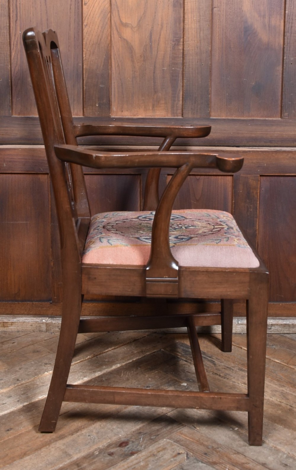 A set of ten dark brown wood dining chairs featuring carved pierced splat backs and patterned drop-in upholstered seats. View VI