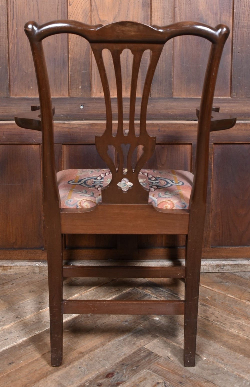 A set of ten dark brown wood dining chairs featuring carved pierced splat backs and patterned drop-in upholstered seats. View VII