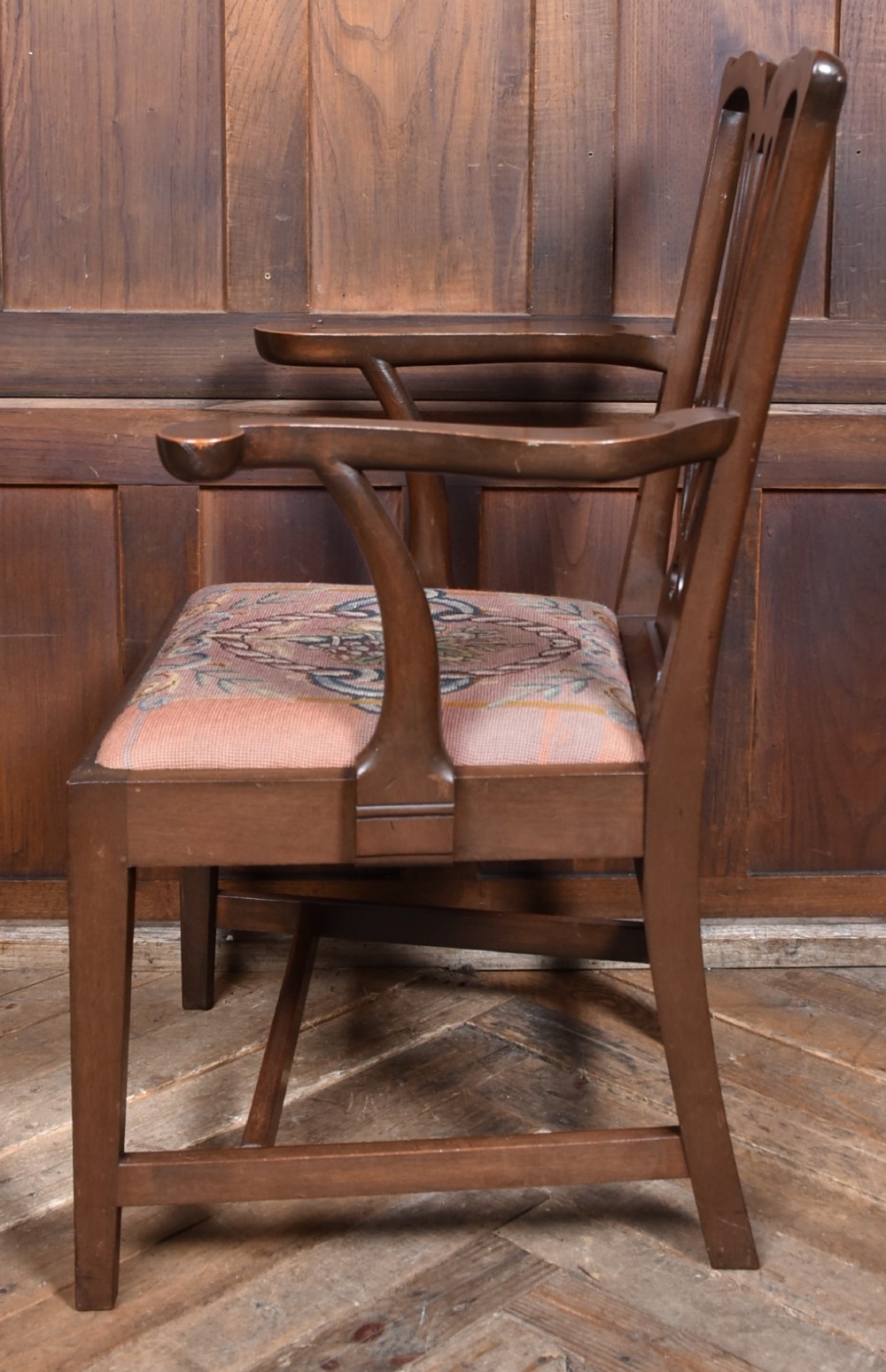 A set of ten dark brown wood dining chairs featuring carved pierced splat backs and patterned drop-in upholstered seats. View VIII